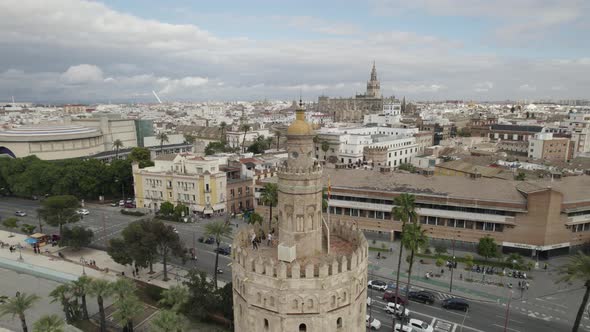 Orbiting view tourists on torre del oro, Guadalquivir riverside, Seville cityscape, Spain