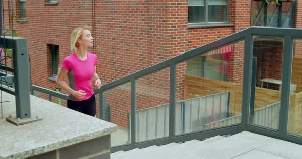 Young Fit Woman Jogging on the Stairs in the City