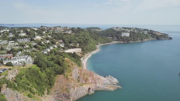 Aerial view of a beach in Torquay in southwest England. Coastline view from the sky of a town in Dev