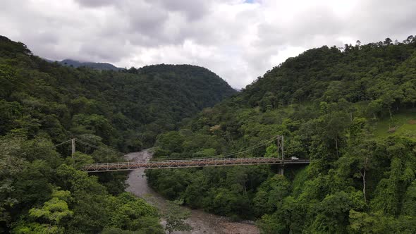 4k aerial footage of the puente rio penas blancas during green season. Slow half circle flight aroun