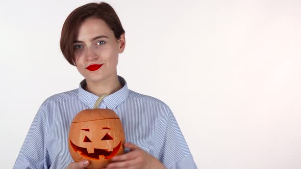 Happy Woman Showing Thumbs Up, Holding Halloween Carved Pumpkin