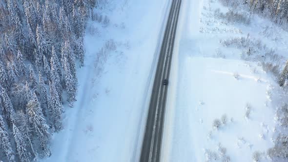 Highway Through the Winter Forest Aerial Photography From UAVs