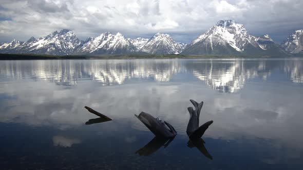 Snow capped Grand Teton Mountains reflecting in Jackson Lake