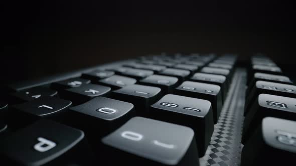 Close-up view of computer keyboard. Macro soft focus dolly shot