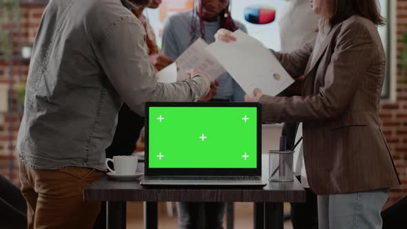 Close Up of Coworkers Having Laptop with Green Screen on Desk