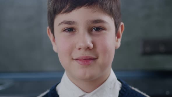 Closeup Portrait of 1213 Years Old Boy Looking at Camera at Home