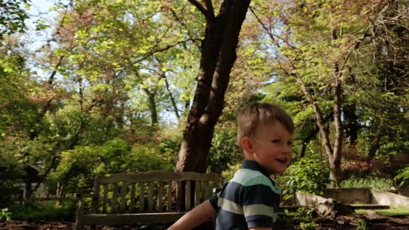 Happy Boy Runs on the Grass in the Park