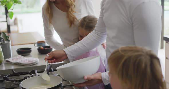 Family preparing food in kitchen at home 4k