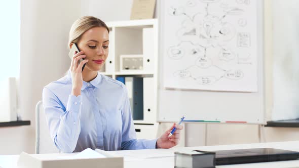 Businesswoman Calling on Smartphone at Office 32