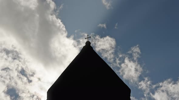 Timelapse of clouds passing church roof