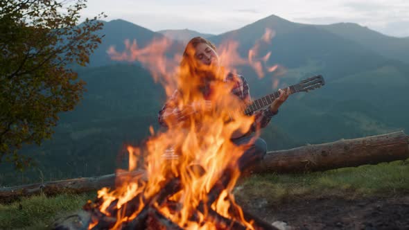 Smiling Woman Play Guitar in Mountains