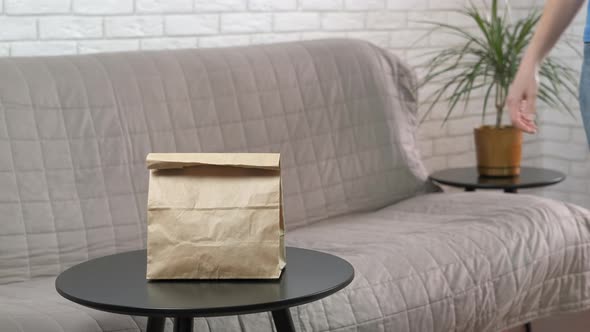 Woman Puts Take Away Bag