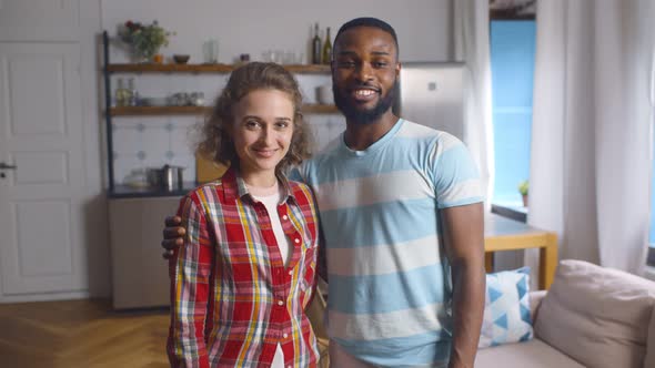 Portrait of Smiling Cheerful Man and Woman in Love in Modern Aparnmtent