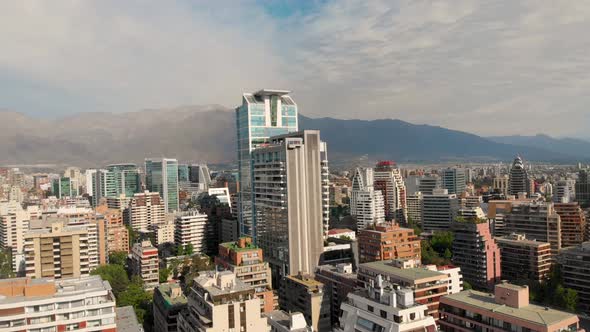 Flying over the city closing on Skyscraper on a sunny day, Santiago Chile-4K