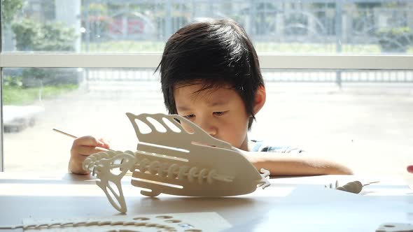 Cute Asian Child  Builds A Toy Of Wood