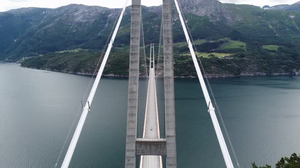 Upwarding aerial with panoramic view ower Hardanger bridge - Passing close to cables holding bridge