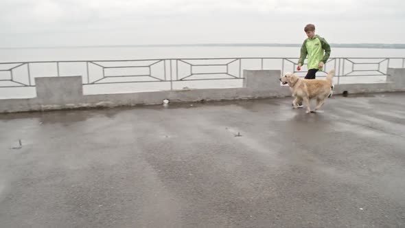 Young Pet Lover Playing with Dog