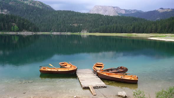 Tourist boats near wooden pier on Black lake in Montenegro, Europe