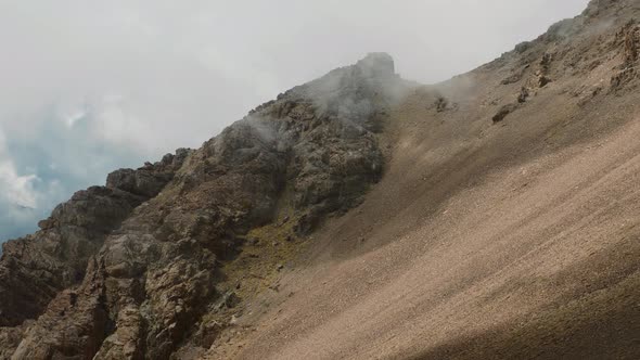 Clouds moving fast over high altitude mountain in High Atlas, Morocco, static