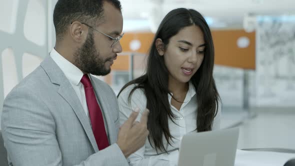 Business Colleagues with Laptop and Papers