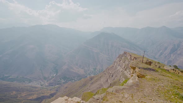 Green mountain valley with rocks in haze