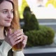 Girl Sit in a Cafe on the Street Drinking Tea - VideoHive Item for Sale
