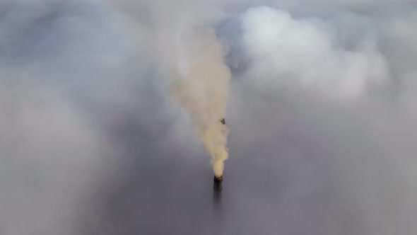 Coal Power Plant High Pipes Emitting Black Poisonous Smoke Moving Upwards Over White Fog Polluting