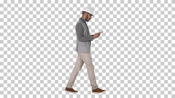 Young architect reading textbook or notebook while walking