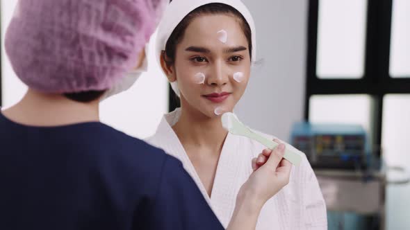 Beauty clinic concept. Young woman getting professional facial procedure.