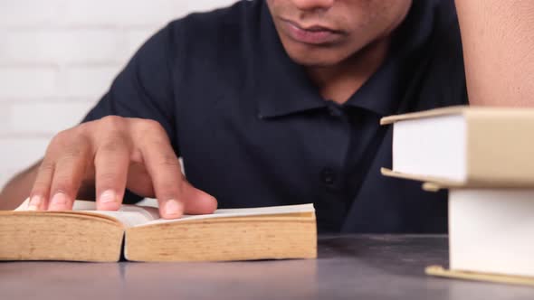 Close Up of Young Man Hand Reading a Book