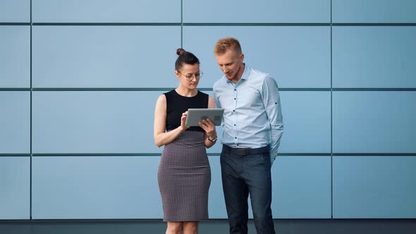 Two Business People Man and Woman Greeting Each Other Shaking Hands Outdoor Using Tablet Pc