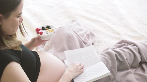 Pregnant Woman Eating and Reading