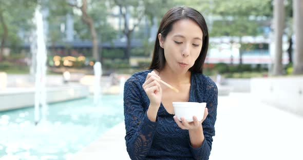 Woman eating fish ball in Hong Kong, famous local food 