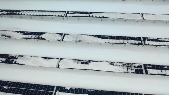 Aerial View of a Snow on Solar Panels Farm in Winter