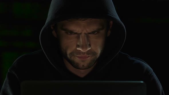 Focused man carefully working on computer, system administrator of web sites