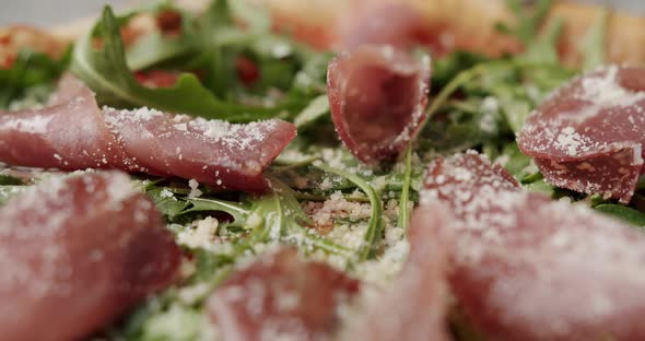 Close Up Pizza with Prosciutto Parma Ham Arugula Salad Rocket with Ingredients