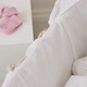 Baby girl sleeping in bassinet, with baby clothes beside - VideoHive Item for Sale