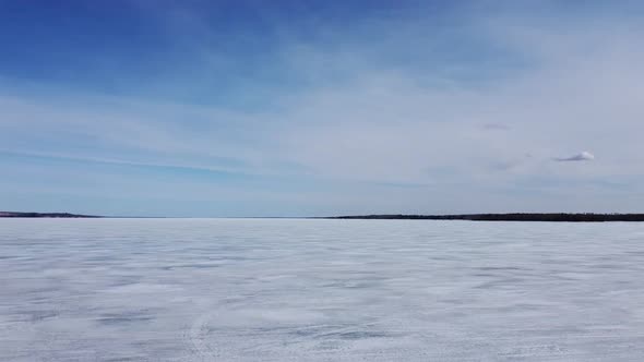 Dolly Along Frozen Lake Blue Sky