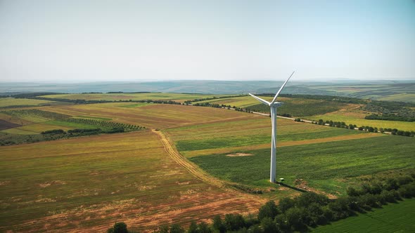 Aerial drone view of working wind turbine in Moldova. Wide fields around it