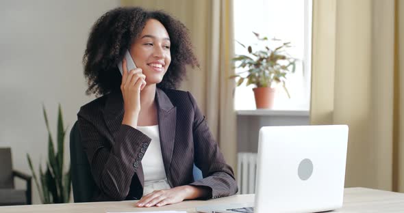 Close Up Businesswoman Sit Indoors at Office Talks on Phone Makes Arrange with Client, Provide