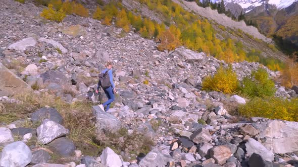 A young beautiful slender woman alone in the mountains.