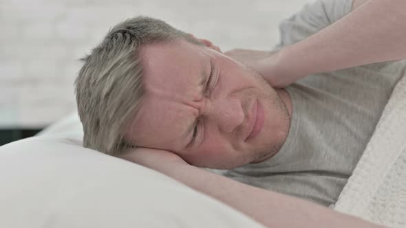 Man Having Neck Pain While Sleeping