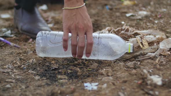 Hand Picking Up Bottle