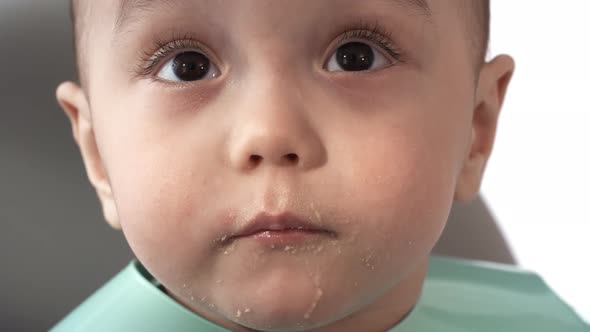 Inquisitive Asian Baby Looking Around at Mealtime