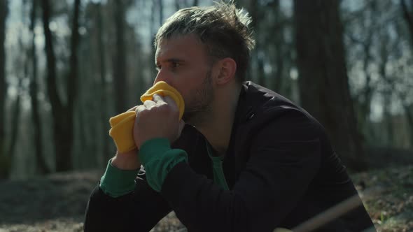 A Sad Man Is Sitting Alone on the Ground By a Tree Suffering Emotional Pain and Thinling About