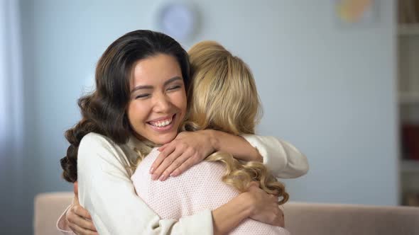 Two Young Women Hugging and Sincerely Smiling, True Old Friendship, Indoors