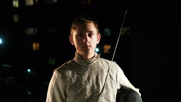 Portrait Of Young Fencer Man Looking Into Camera On The Street.