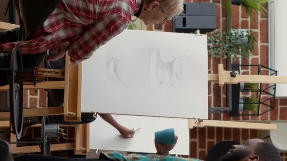 Vertical Video Modern Artist Analyzing Vase Drawing By Senior Woman