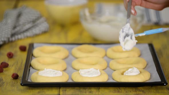 Baking homemade open patties with cottage cheese and raspberries