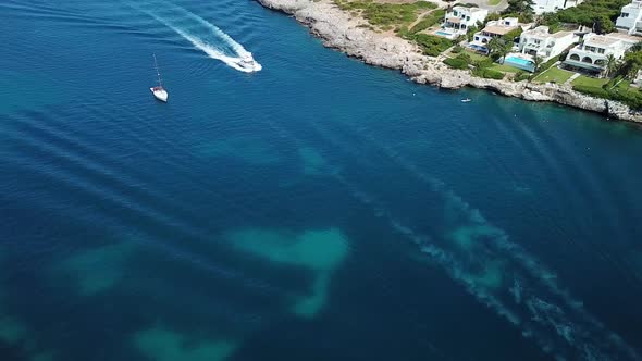 Aerial: The bay of Cala D'Or resort town in Mallorca, Spain